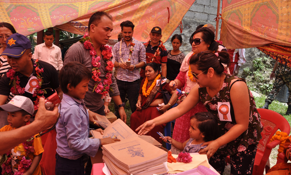 Member of the Gopal-Pramila trust Ms. Akanksha Chhetri and Baby Aura Rajshree Bista distributed copy and pens to the students of Thumka Primary School, Gorkha on May 27, 2017.